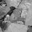 Oblique aerial view centred on the cropmarks of the fort, ring ditch, pits and rig at Mains of Edzell with the farmstead adjacent, looking to the NNW.