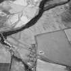 Oblique aerial view centred on the cropmarks of the pit defined cursus, unenclosed settlement, ring ditches, pits and rig with Stracathro Roman Fort and Temporary Camp adjacent at Inchbare North, looking to the NE.