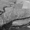 Oblique aerial view centred on the cropmarks of the unenclosed settlement, ring ditches, pits and rig with Stracathro Roman Fort and Temporary Camp adjacent at Smiddyhill, looking to the SW.