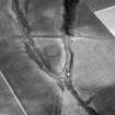 Oblique aerial view centred on the cropmarks of a rectlinear enclosure, possible souterrains, pits and rig at Chapel Knap, looking to the SE.