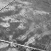 Oblique aerial view centred on cropmarks of the unenclosed settlement, roundhouses, pits and rig at Pittengardner, looking to the ENE.