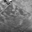 Oblique aerial view centred on cropmarks of the unenclosed settlement, roundhouses, pits and rig at Pittengardner, looking to the WNW.