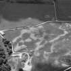 Oblique aerial view centred on the cropmarks of the timber hall, ring ditch, enclosures and pits at Mondobbo House, looking to the WSW.