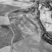 Oblique aerial view centred on the cropmarks of an enclosure, roundhouses, a possible four poster stone circle, possible souterrains, pits and rig at Pitcarry, looking to the SE.