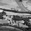 General oblique aerial view centred on Pitcaple Castle with the cropmarks of the enclosure and rig adjacent at Riverbank Wood, looking to the NNW.
