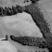 Oblique aerial view centred on the cropmarks of an enclosure and pits at Balhary, looking to the NE.