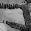 Oblique aerial view centred on the cropmarks of an enclosure and pits at Balhary, looking to the NE.