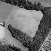 Oblique aerial view centred on the cropmarks of an enclosure and pits at Balhary, looking to the NNE.