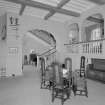 View of main hall in Glenkindie House, Aberdeenshire, showing entrance gallery and principal staircase. Taken from East.
