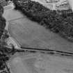 Oblique aerial view centred on the cropmarks of ring ditches, pits and possible souterrains at Nairn, looking to the SSE.