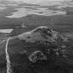 Oblique aerial view centred on the remains of the fort at Mither Tap of Bennachie, looking to the SSE.