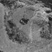 Oblique aerial view centred on the remains of the fort at Mither Tap of Bennachie, looking to the WSW.