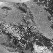 Oblique aerial view centred on the remains of the fort at Mither Tap of Bennachie, looking to the ENE.