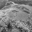 Oblique aerial view centred on the remains of the fort at Mither Tap of Bennachie, looking to the NE.