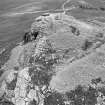 Oblique aerial view centred on the remains of the fort at Mither Tap of Bennachie, looking to the NNW.