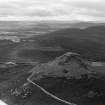 Oblique aerial view centred on the remains of the fort at Mither Tap of Bennachie, looking to the S.