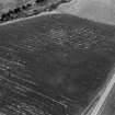 Oblique aerial view centred on the cropmarks of the circular enclosure at Barflat, looking to the SSE.