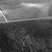 Oblique aerial view centred on the cropmarks of the circular enclosure at Barflat, looking to the WNW.