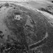 Oblique aerial view centred on the remains of the tower house and fort at Dunideer, looking to the ESE.