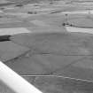 General oblique aerial view centred on the remains of the recumbent stone circle at Ardlair, looking to the SSW.