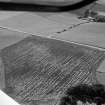 Oblique aerial view centred on the cropmarks of the circular enclosure at Barflat, looking to the WSW.