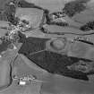 Oblique aerial view centred on the remains of the castle and motte of Doune of Invernochty, looking to the SE.