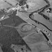 Oblique aerial view centred on the remains of the castle and motte of Doune of Invernochty, looking to the NE.