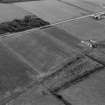 Oblique aerial view centred on the cropmarks of a circular enclosure at Ardmorn, looking to the SW.