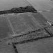 Oblique aerial view centred on the cropmarks of a circular enclosure at Ardmorn, looking to the S.