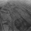 Oblique aerial view centred on the cropmarks of the unenclosed settlement, ring ditches, souterrains and rig at Westside, looking to the NW.