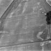 Oblique aerial view centred on the cropmarks of the ring ditches, enclosures and pits at Newbarns, looking to the SE.