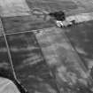 Oblique aerial view centred on the cropmarks of the unenclosed settlement, rectilinear enclosures, souterrains, barrows, ring ditches, linear features and pits at Newbarns, looking to the NNE.