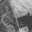 Oblique aerial view centred on the cropmarks of the Roman Temporary Camp and Fort with the churchyard adjacent at Stracathro, looking to the SW.