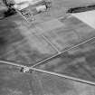 Oblique aerial view centred on the cropmarks of the roundhouses and ring ditches of the unenclosed settlement at Newbigging, looking to the NNW.