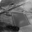 Oblique aerial view centred on the cropmarks of the Roman Temporary Camp, ring ditches, enclosure, lienar features, pits and rig at Dun and Gilrivie, looking to the NNW.