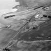 Oblique aerial view centred on the cropmarks of the Roman Temporary Camp, unenclosed settlement, linear features, pits and rig at Gilrivie, looking to the SW.