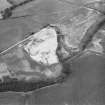 Oblique aerial view centred on the cropmarks of the unenclosed settlement, ring ditches, souterrain, pit alignment, rig and linear features at Arrat's Mill, looking to the NE.