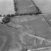 Oblique aerial view centred on the cropmarks of the rectinlinear enclosure, rig and the site of Magdalene's Chapel, looking to the N.