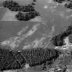 Oblique aerial view centred on the cropmarks of the unenclosed settlement, roundhouses, souterrains, pits and rig at Kinnaird Castle, looking to the NNW.