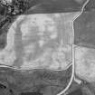 Oblique aerial view centred on the cropmarks of the enclosure, ring ditch, possible pit alignment, pits and rig at Pitcarry, looking to the WNW.