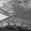 Oblique aerial view centred on the cropmarks of the unenclosed settlement, ring ditches, enclosures, rig and pits at Inverkeilor and Ironshill, looking to the SE.