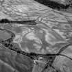 Oblique aerial view centred on the cropmarks of the enclosure, timber hall, unenclosed settlement and pits at Boysack, looking to the SW.