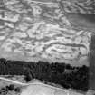 Oblique aerial view centred on the cropmarks of the unenclosed settlement, roundhouses, rig and pits at Chapelton and Westfield, looking to the ENE.