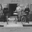 View of three men with bikes outside house. Inscribed beneath: 'As we started from 2 Corrennie Gardens. July 20th 1903.'