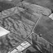 Oblique aerial view centred on the cropmarks of the pit defined cursus, enclosed cremation cemetery, ring ditch and rig at Balneaves, looking to the SE.