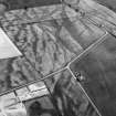 Oblique aerial view centred on the cropmarks of the pit defined cursus, enclosed cremation cemetery, rectilinear enclosure, ring ditch and rig at Balneaves, looking to the SE.
