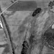 Oblique aerial view centred on the cropmarks of the linear features, Roman temporary camp, pits and rig with the farm adjacent at Gilrivie and Dun, looking to the ESE.