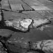 Oblique aerial view centred on the cropmarks of the unenclosed settlement, ring ditches, souterrain, pit alignment, rig and linear features at Arrat's Mill, looking to the NNW.