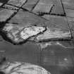 Oblique aerial view centred on the cropmarks of the unenclosed settlement, ring ditches, souterrain, pit alignment, rig and linear features at Arrat's Mill, looking to the N.