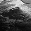 Oblique aerial view centred on the remains of the vitrified fort at Tap O' Noth, looking to the S.